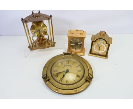 Four clocks to include a porthole style wall clock, anniversary clock and similar. [W]