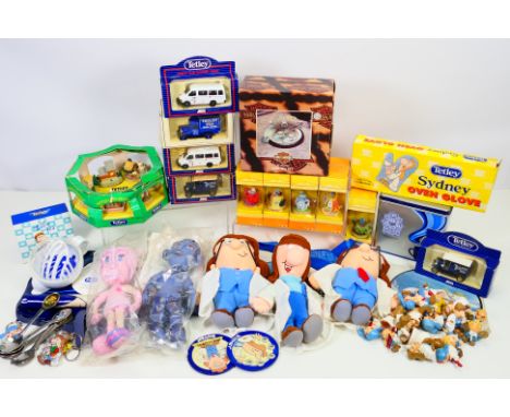 A collection of promotional / advertising items to include Tetley diecast vehicles, figures, oven glove, Comfort Darren and L