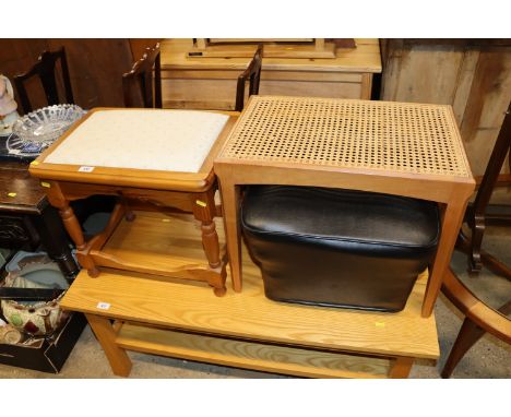 A pine dressing table stool; a cane seated stool; and a vintage leather upholstered pouffe