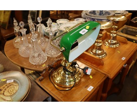 A brass desk lamp with green glass shade 