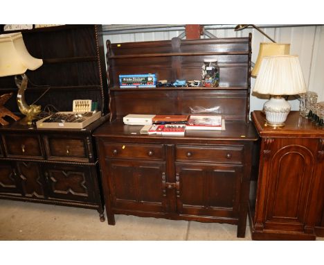 An Ercol dresser raised on cupboard base fitted two drawers 