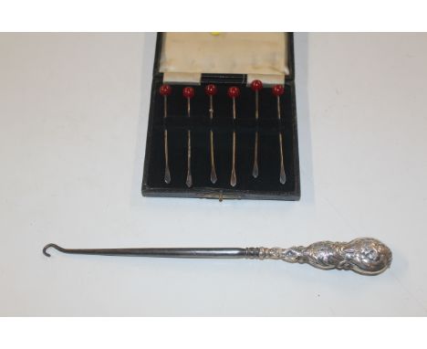 A set of six silver cocktail sticks and a silver handled button hook AF