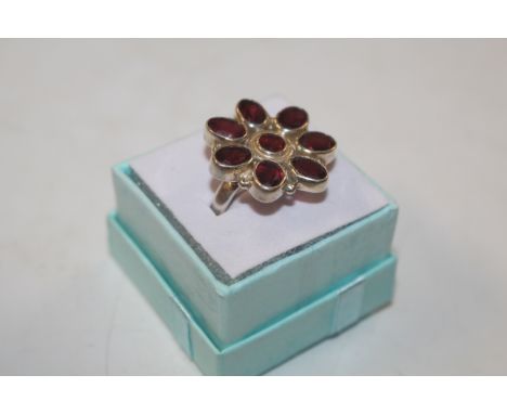 A large Sterling silver and garnet dress ring 