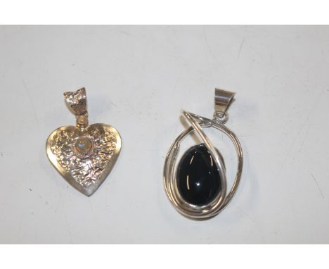 A large Sterling silver and black onyx pendant; and a Sterling silver planished finish and opal pendant 