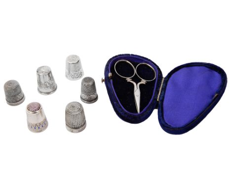 Six silver and other thimbles and a cased set of steel embroidery scissorsto include a Norwegian thimble by Clement Berg, dec