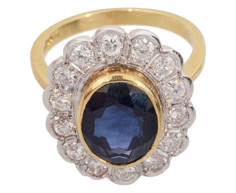 A sapphire and diamond-set ring, the oval mixed-cut sapphire collet-set above the border of brilliant-cut diamonds to the 14c