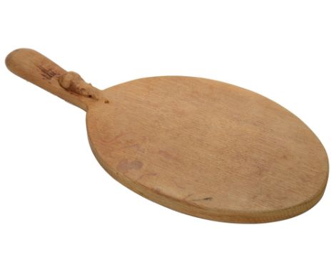 A Robert 'Mouseman' Thompson of Kilburn oval oak cheese board with handlebearing carved mouse signature to handlelength 38 cm