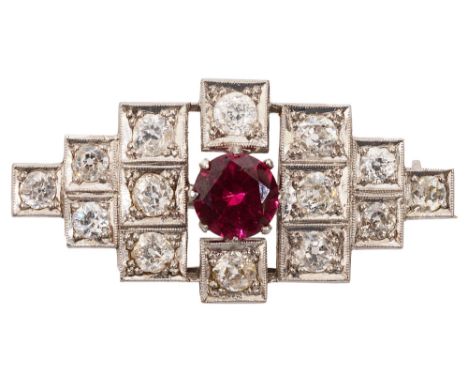 An Art Deco style ruby and diamond brooch, of geometric design, the central circular-cut ruby (untested but probably syntheti