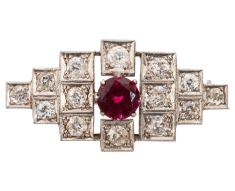 An Art Deco style ruby and diamond brooch, of geometric design, the central circular-cut ruby (untested but probably syntheti