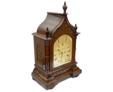 A large Victorian Gothic walnut cased bracket clockthe arched silvered dial with Roman numerals, minute track, STRIKE/SILENT 