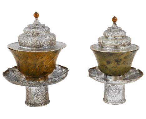 Two Tibetan nephrite jade and white metal stems bowls and covers c.1900the spinach bowls both a/f, the stands with lobed peta