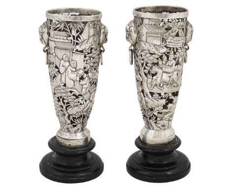 A pair Chinese export silver vases c.1900unmarked of tapering pierced form with twin mask ring handles, decorated with a land