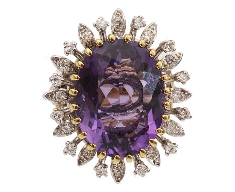 An amethyst and diamond-set cluster ring, the central oval amethyst claw-set above the alternating foliate and circular motif