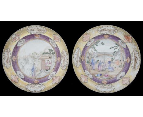 A pair of Chinese export famille rose Mandarin pattern platesc. 1800, decorated with figures in landscape settings, inside a 