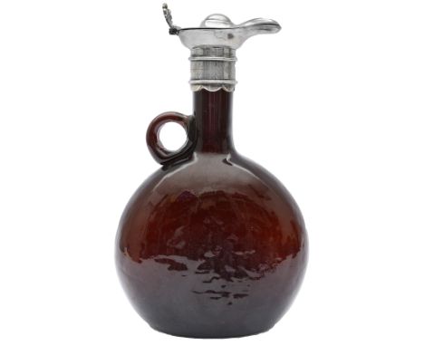 A 19th century brown glass spirit decanter with silver plated mountof flagon form with ring handle, the mount with domed hing