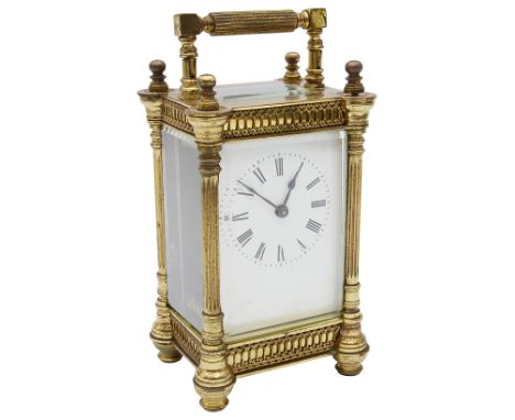 A late 19th century French gilt brass carriage clock the white enamel dial with Roman numerals and minute markers, 8 day move
