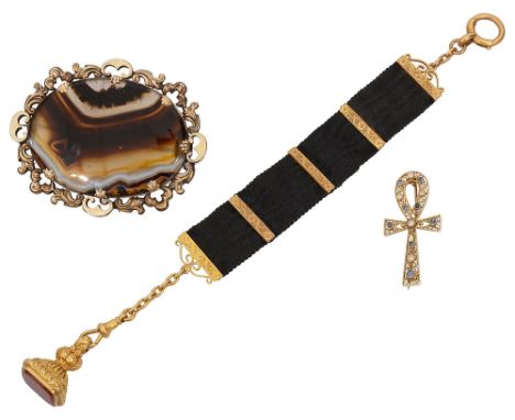 A Victorian gold and carnelian-set fob seal suspended from a black moirŽ silk ribbon with foliate chased 18ct gold mounts; a 