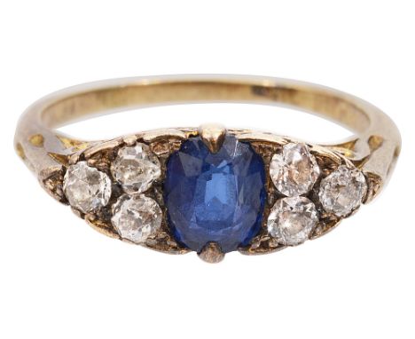 A late Victorian sapphire and diamond-set ring,the central oval mixed-cut sapphire set to either side with three old brillian