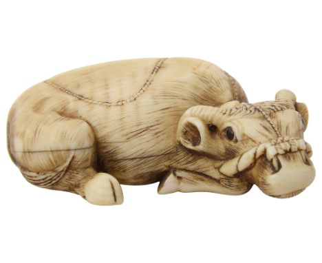 A Japanese ivory netsuke in the form of a recumbent water buffalo, early 20th century, character mark to base,width 5.25cmCon