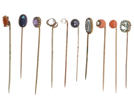 Ten late 19th/early 20th century stick pins: two set with coral beads, one with a star motif with pearl to the centre, a blac