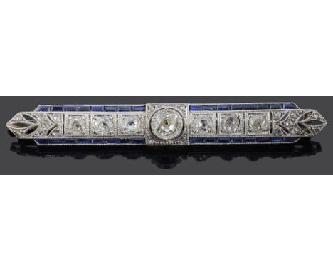 An Art Deco diamond and sapphire-set brooch, of openwork shaped rectangular design, centrally-set with an old brilliant-cut d