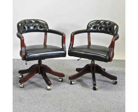 A pair of green leather upholstered button back desk chairs