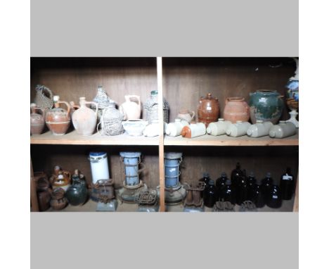 A collection of vintage heaters, largest 52cm high, together with a collection of stoneware jars and hot water bottles, vario