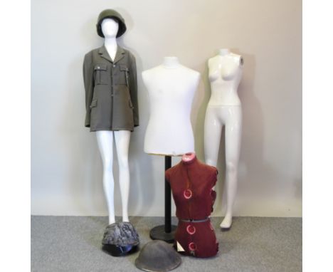 A mannequin, together with two others, a military uniform and a chair