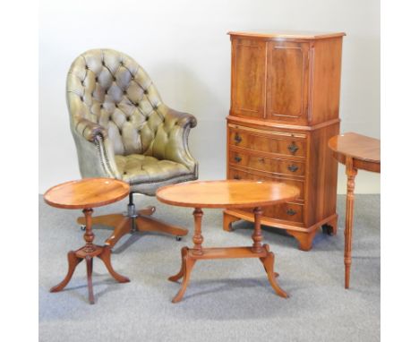 A green leather upholstered button back swivel desk chair, together with a reproduction yew wood cabinet and three similar oc