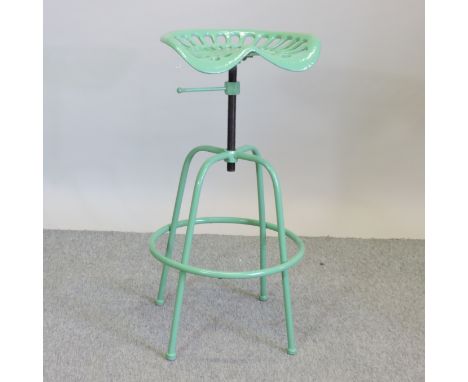 A pair of green painted tractor seat stools