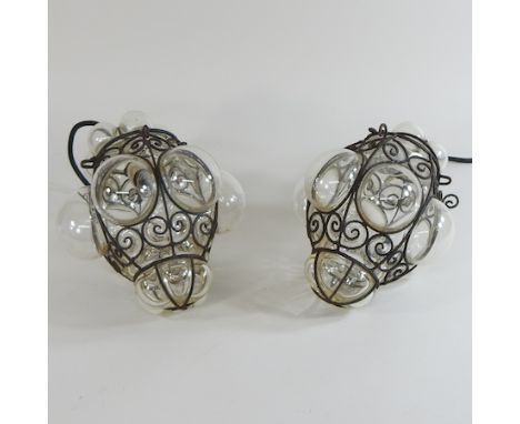A vintage wirework and glass lantern, 30cm high, together with another smaller