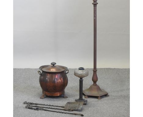 An Art Nouveau style copper cauldron and lid, 38cm high, together with an oil lamp base, a standard lamp and fire tools