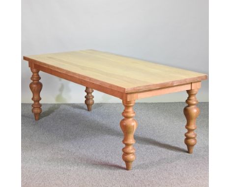 A handmade light oak dining table, on turned legs, 200 x 90cm