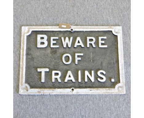 A vintage cast iron 'Beware of trains' sign, 39 x 57cm