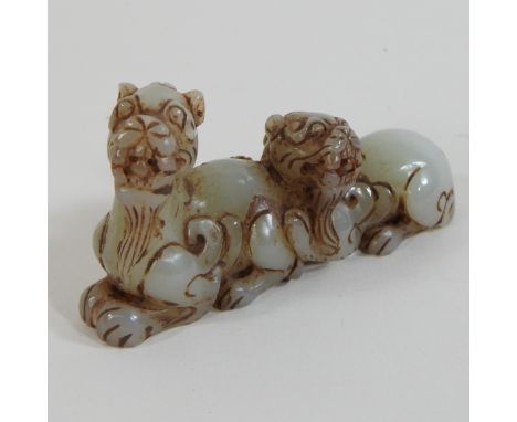 A jade coloured carving of two dogs of Fo, 7cm