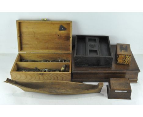 A collection of treen, including a carved model of a boat with a possible museum label to the inside, four hinged boxes, one 