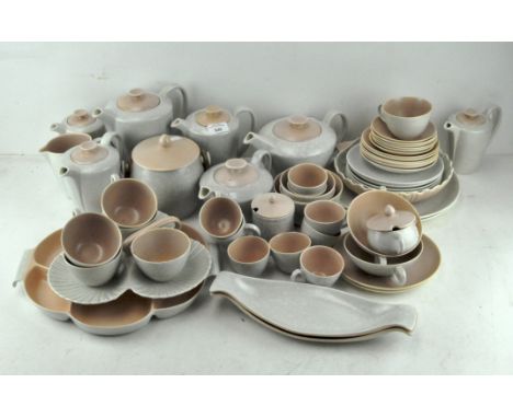 An extensive collection of Poole pottery, to include teapots, cups, butter dishes, bowls and more