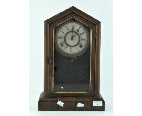 A mid century American mantel clock, wooden cased, the dial with Roman numerals denoting hours, 43cm high