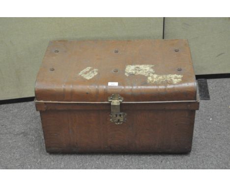 A vintage metal trunk, painted brown with brass fittings and stickers to the outside, width 64cm