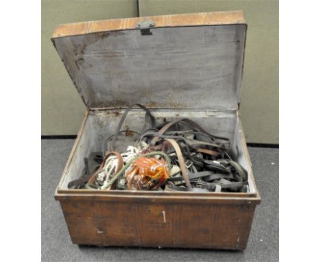 A vintage tin storage trunk, 76cm wide x 52cm high x 54cm deep, opening to reveal a collection of  horse tack