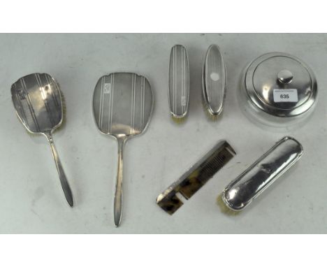 Assorted silver dressing table items, most with engine turned detailing, including brushes, a mirror and powder jar