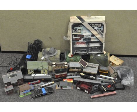 A collection of model railway related items, including scenery, track, switches, miniature houses and other items