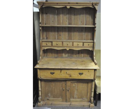 A pine dresser, the plate rack with 5 spice drawers on a base with a single drawer above a pair of doors, 197 high x 115cm wi