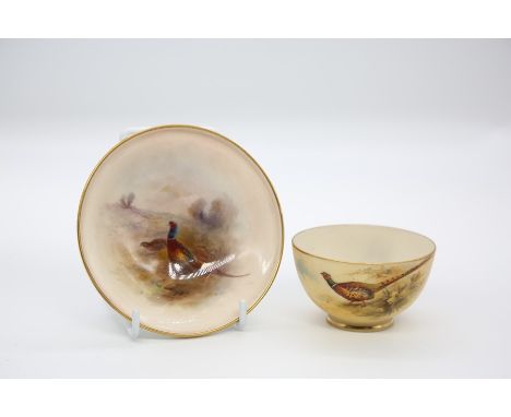A Royal Worcester circular pin dish with foot rim, shape no: 2769, the body painted with a pair of Pheasants, signed by James