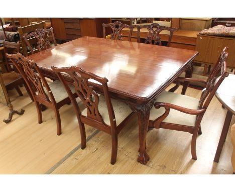 A modern mahogany dining table and a set of six chairs, in the manner of Chippendale