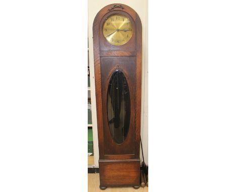 A George V oak longcase clock, brass dial, the mechanism striking on gongs