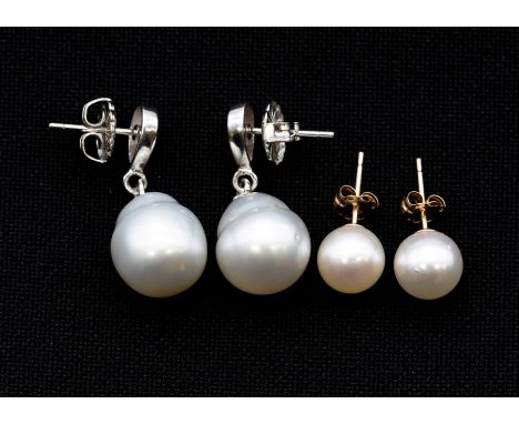 A pair of of cultured South sea pearl and silver earrings, comprising a pear shaped silver top suspending a white pearl appro