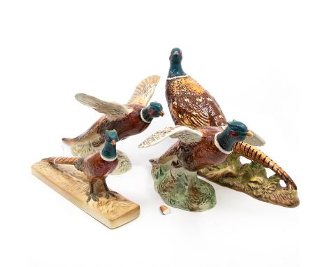 A group of four Beswick Pheasants, two walking, two in flight - model numbers include: 1225; 1774, 849 &amp; 850 (4) (damage 