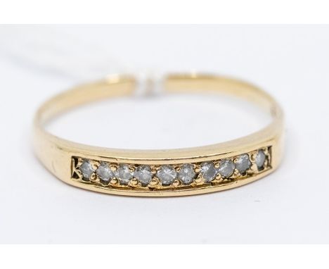 A yellow metal diamond set half eternity ring, probably 14ct gold, set with 10 individually set faced diamonds, ring size R 1