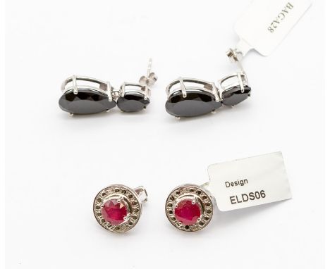 A pair of&nbsp;ruby and diamond&nbsp;silver earrings, round form&nbsp;each set to the centre with round cut claw set ruby, to